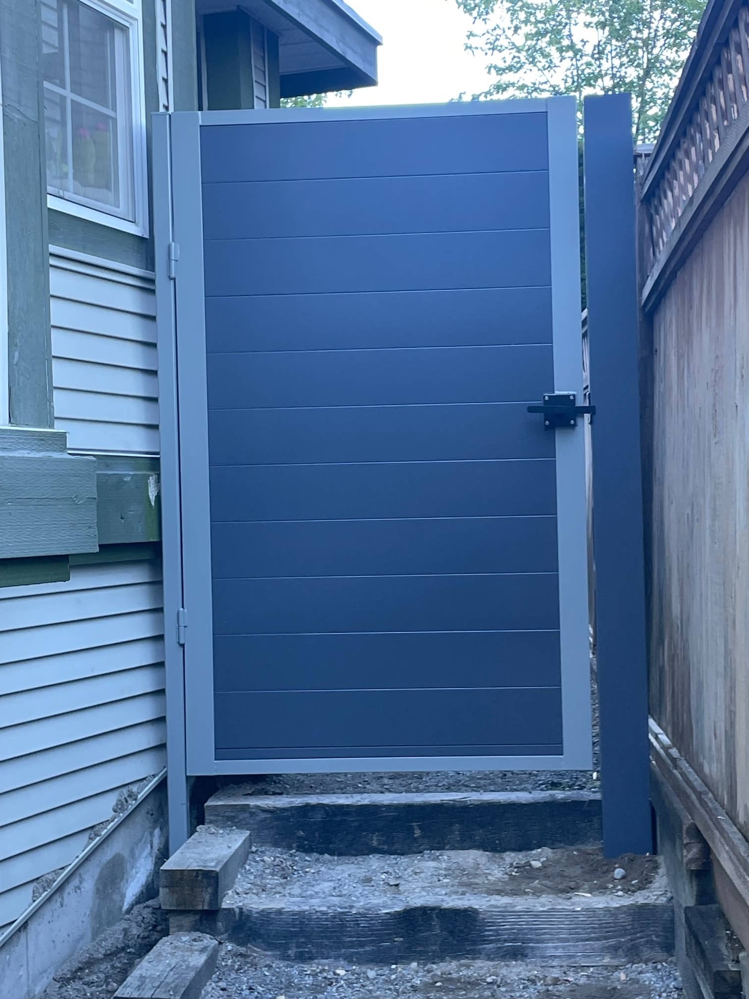 metal panels installation and design of blue fence in Coquitlam
